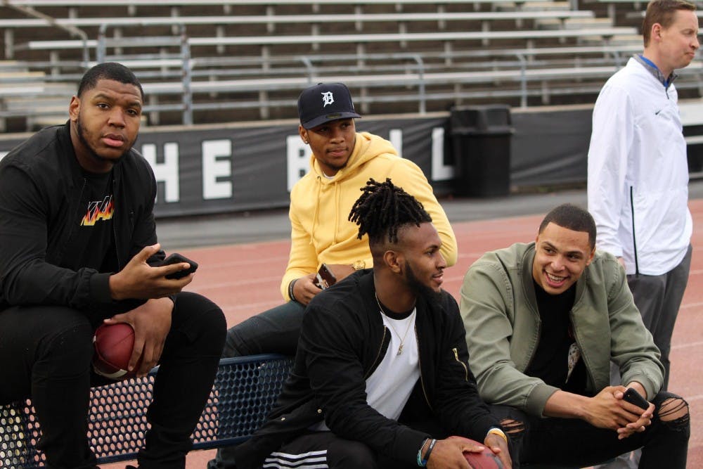 <p>UB football alum Chuck Harris, Cameron Lewis, Anthony Johnson and Tyree Jackson sit on the sidelines during the annual spring football game. All four signed with an NFL team this weekend.</p>
