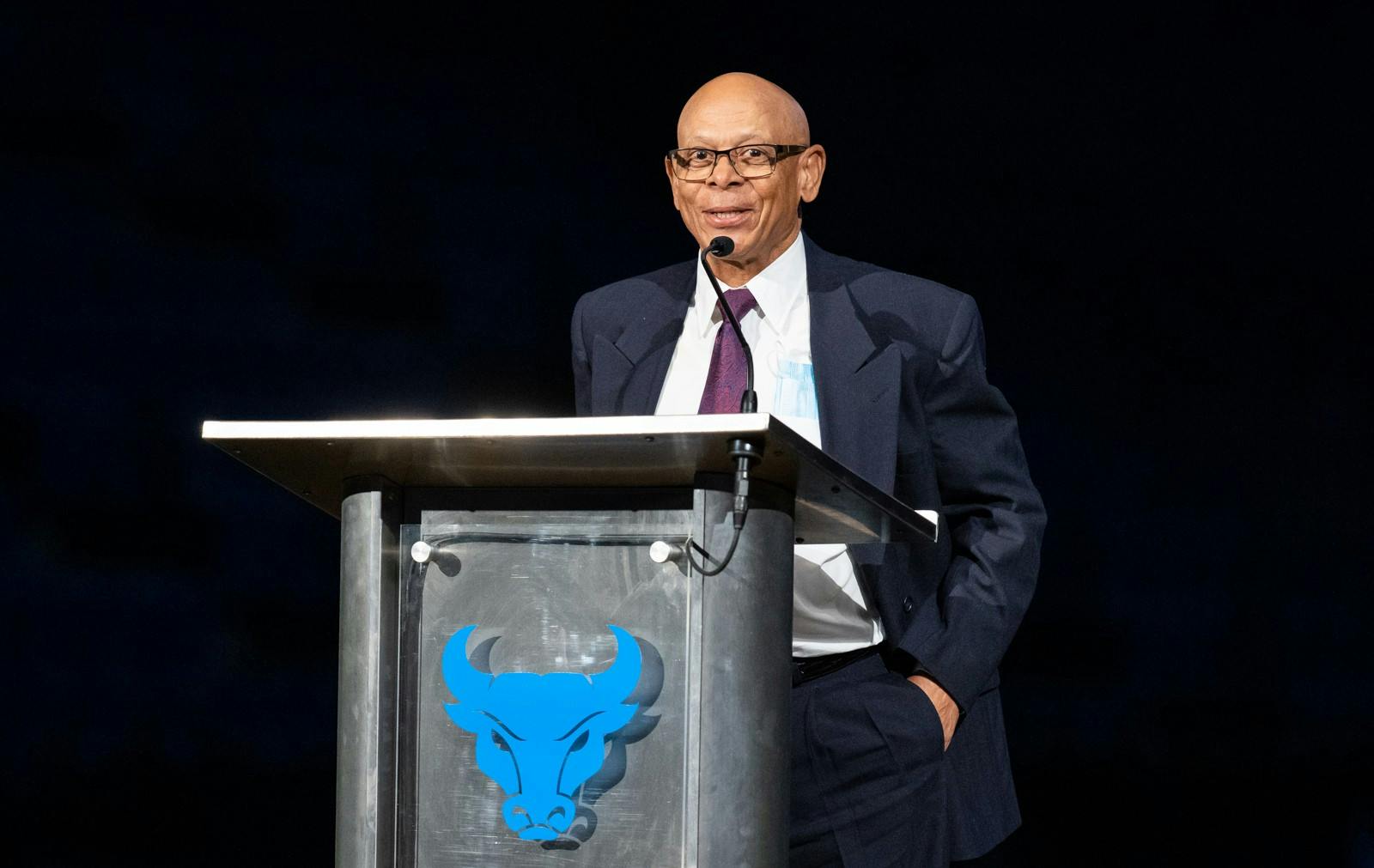 UB Athletic Director Mark Alnutt (right) and former hockey head coach Ed Wright (left) stand onstage during the 2022 UB Athletics Hall of Fame induction ceremony.