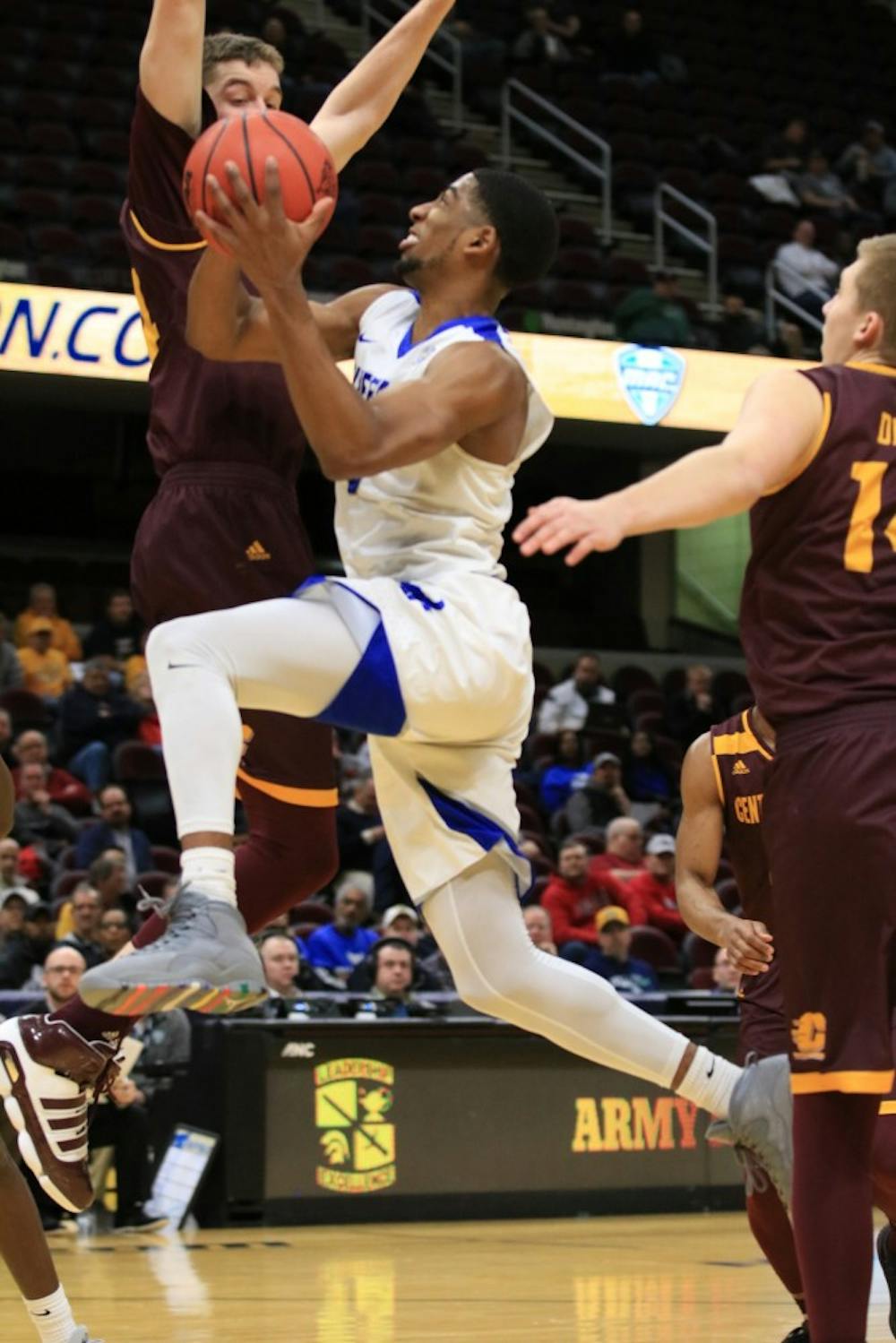 <p>Junior guard CJ Massinburg fights through contact for the basket. He  finished with 18 points, 5 rebounds and 4 assists to help the  Bulls advance to the semifinals.</p>