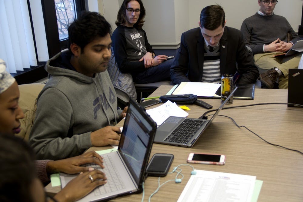 <p>SA Senate Chair Devashish Agarwal speaking on the phone with newly appointed Vice President Ben Harper at the Thursday night Senate Meeting.</p>