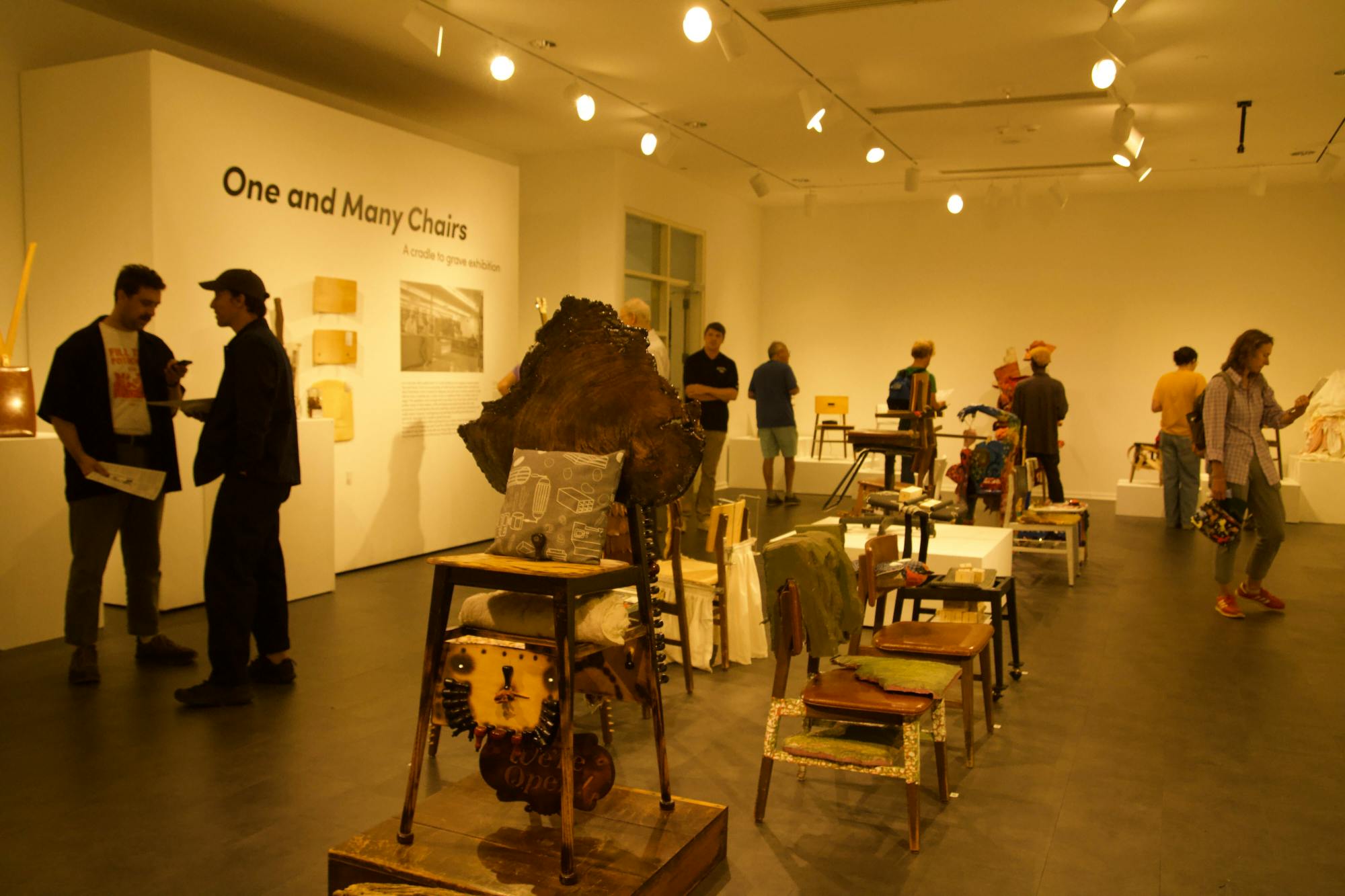 The opening reception for "One and Many Chairs" bustled with guests, artists, and potential buyers.