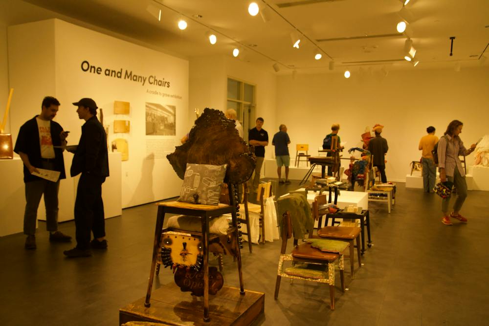 The opening reception for "One and Many Chairs" bustled with guests, artists, and potential buyers.