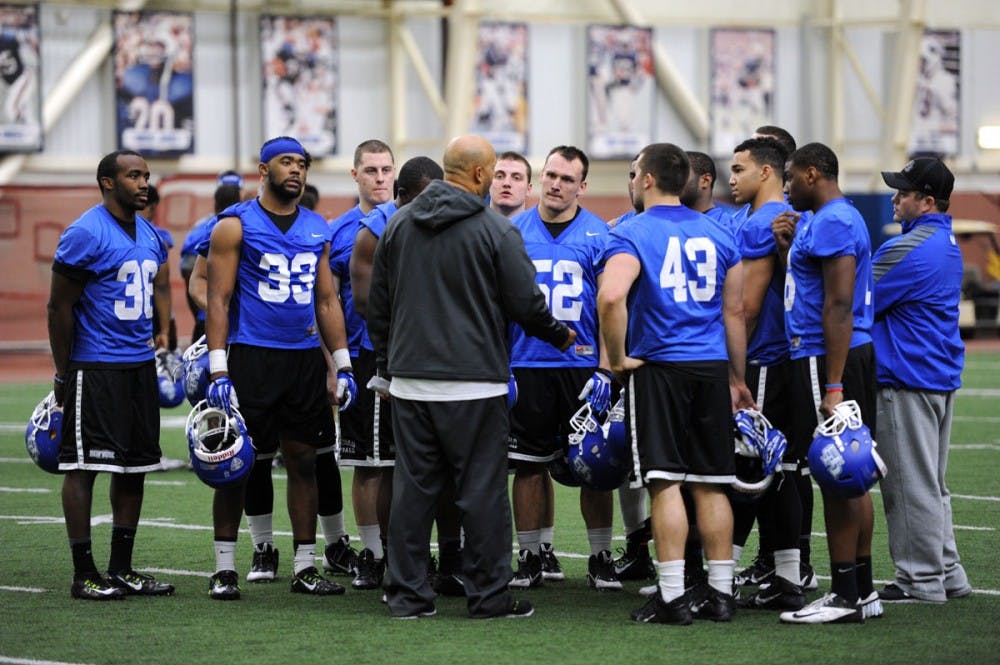 <p>Linebackers head coach Chris Sampson talks to the Bulls' defense during a spring practice in the ADPRO Sports Training Center. The Bulls are making the transition from a 3-3-5 defense to 4-3 defense.</p>