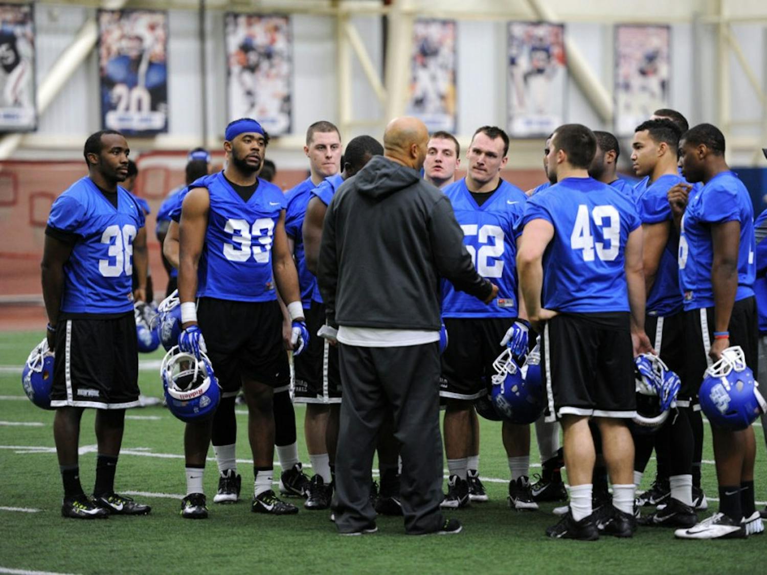 Linebackers head coach Chris Sampson talks to the Bulls' defense during a spring practice in the ADPRO Sports Training Center. The Bulls are making the transition from a 3-3-5 defense to 4-3 defense.