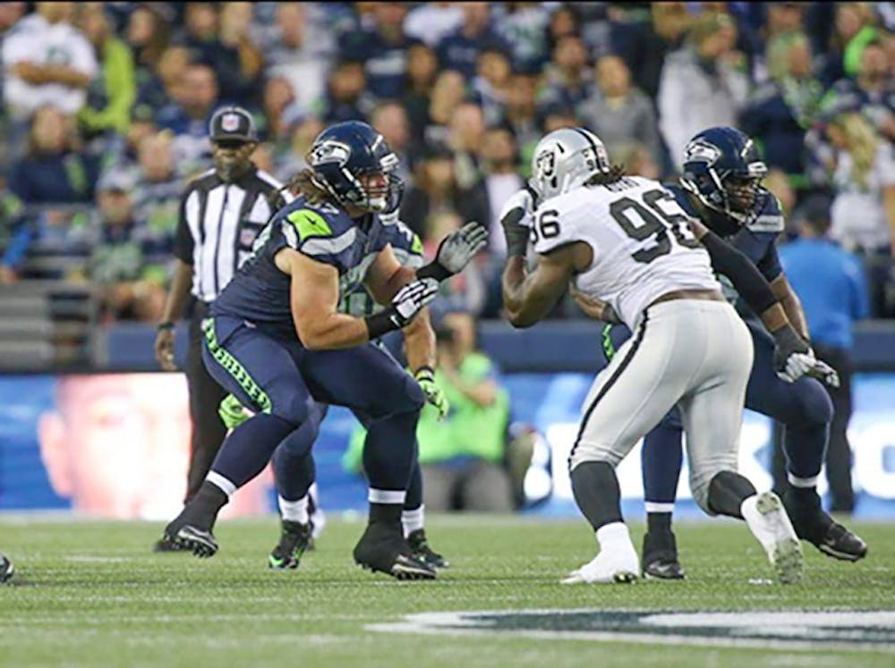 <p>Kristjan Sokoli, now at guard, looks on to block an Oakland Raider defender. Last week, Sokoli made the 53-man roster for the NFC Champion Seattle Seahawks after being drafted in the six round of the NFL draft.</p>