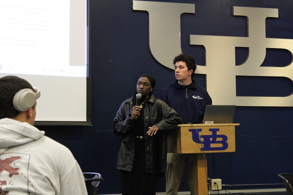 SA President Aisha Adam introduces the resolution that would increase e-board wages by at least three percent during a Senate meeting Wednesday evening.