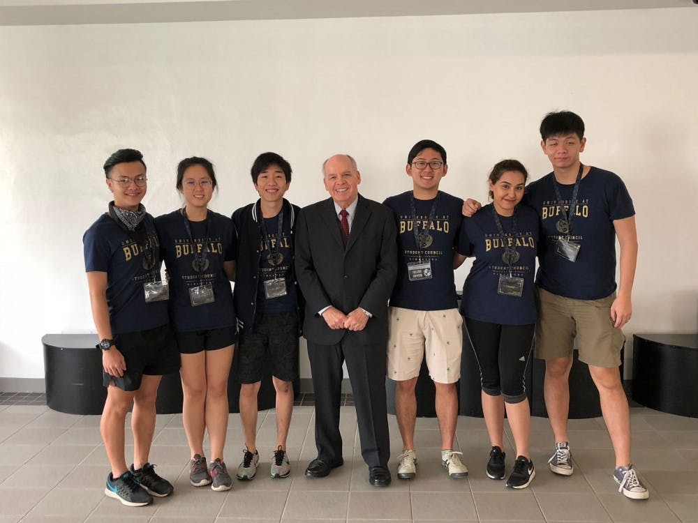 <p>Vice Provost for International Education Stephen Dunnett stands with students in the international program in Singapore in January 2018. On Sept 1. of this year, Dunnett will step down from his position and help the university transition the program before he fully retires on Sept. 1, 2019.</p>