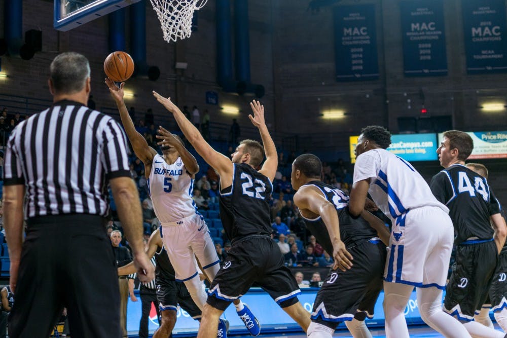 Senior guard CJ Massinburg lays the ball up and in past the Daemon defenders. Massinburg returned after a one game absence Saturday, scoring 21 in a win against the Marist Red Foxes.&nbsp;