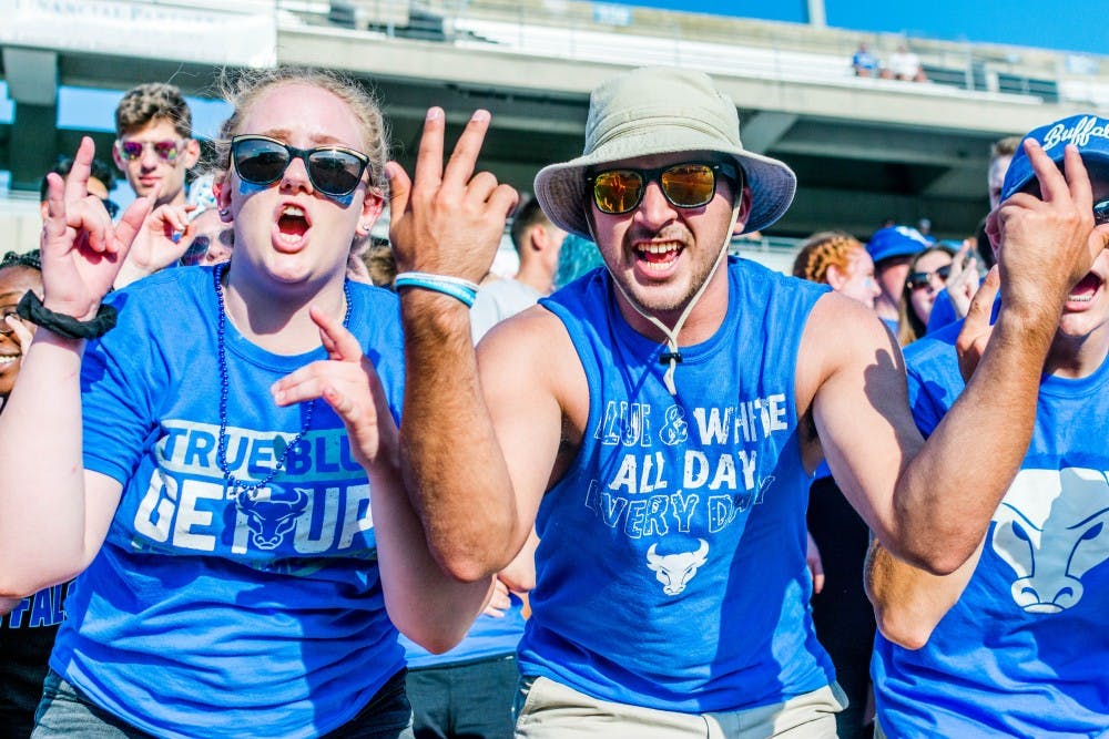 <p>Students celebrating in the stands during the first UB Football game of the 2018 season. The game saw a near 40 percent increase in attendance compared to the 2017 home opener.</p>