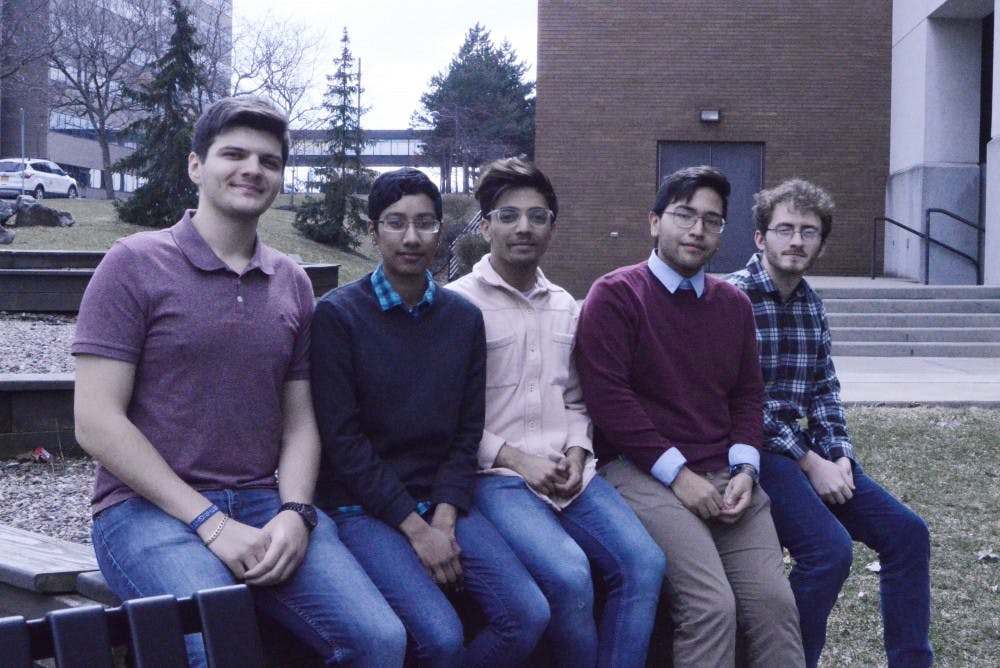 <p>oSTEM members sit outside the Student Union on Wednesday. oSTEM members said the club can reach a different demographic that LGBTA events cannot.</p>