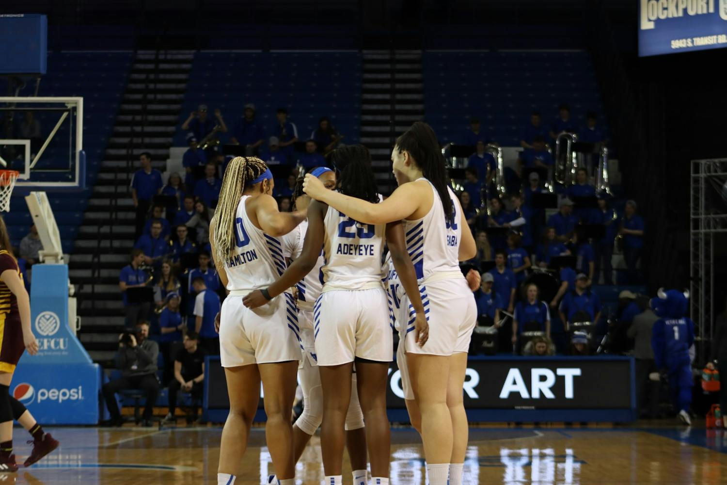 The women's basketball team gather in a team huddle before the start of a game.&nbsp;