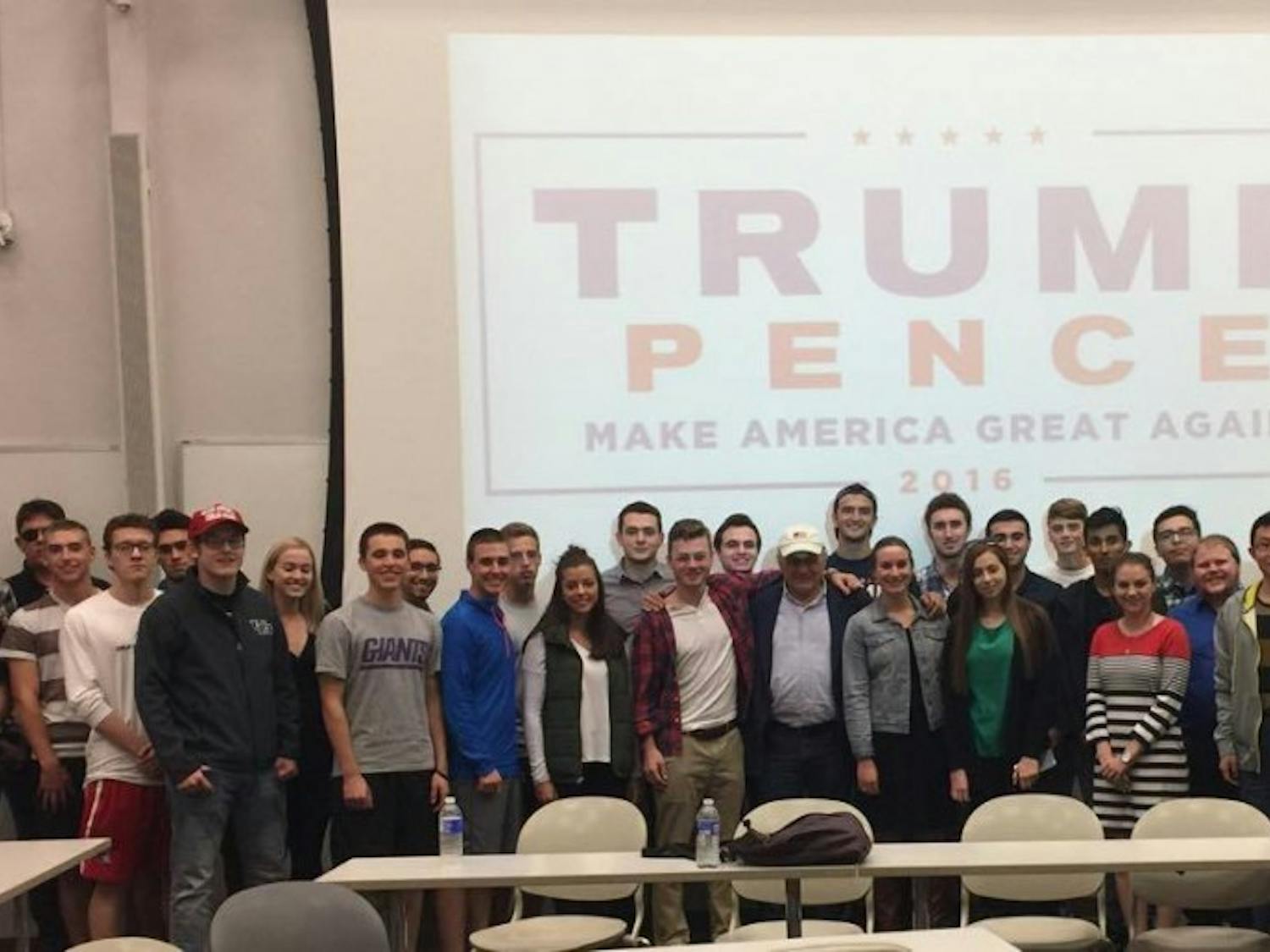 UB College Republicans stand with Carl Paladino in Talbert Hall on Monday night. Paladino, Donald Trump's campaign co-chair, gave his perspective on the presidential election.