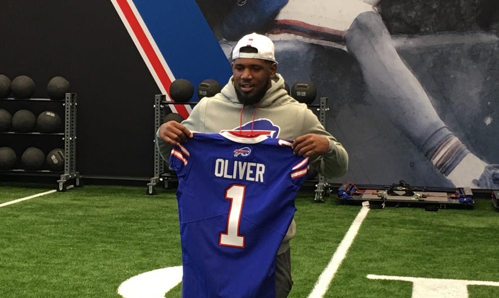 <p>UB football alum Chuck Harris, Cameron Lewis, Anthony Johnson and Tyree Jackson sit on the sidelines during the annual spring football game. All four signed with an NFL team this weekend.</p>