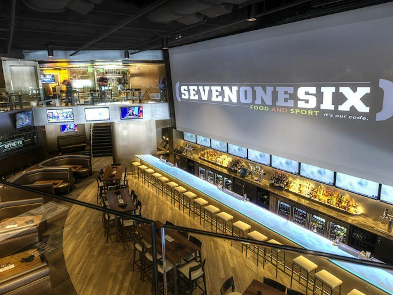 The main bar area at (716) Food and Sport. The bar features a 38-foot-long main TV along with an additional 70 others.
