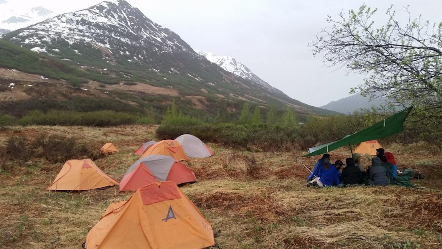 Students huddle while camping in the Alaskan mountains.&nbsp;Outdoor Pursuits and the Outdoor Adventure Club are urging students to participate in this year’s Outdoor Nation Campus Challenge.