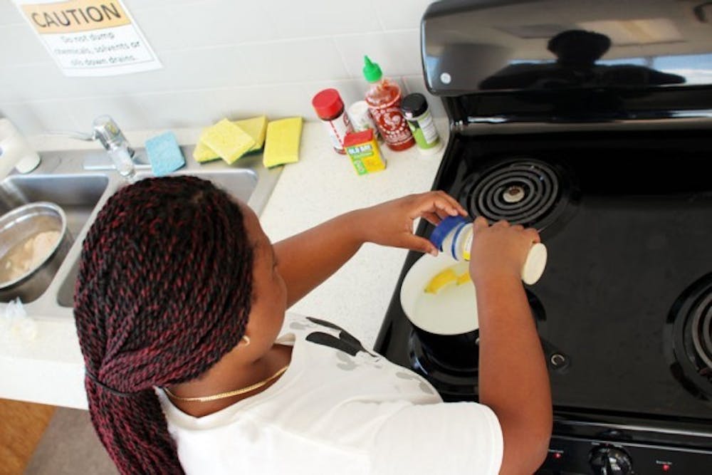 Theresa Blaise, a sophomore biology major, cooks almost every meal in her dorm kitchen to save money and stay healthy. Yusong Shi, The Spectrum