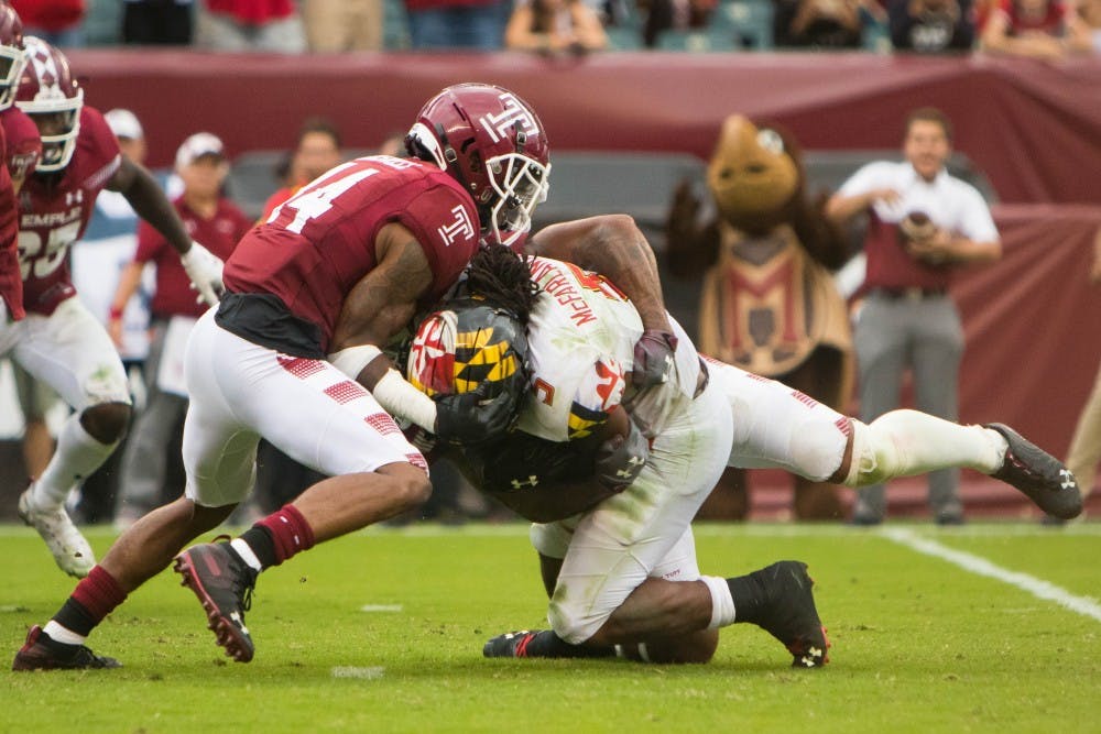<p>Redshirt-sophomore cornerback Christian Braswell (left) assists senior linebacker Shaun Bradley in a tackle during the fourth quarter in the Owls' game against Maryland at Lincoln Financial Field on Sept. 14, 2019.</p>