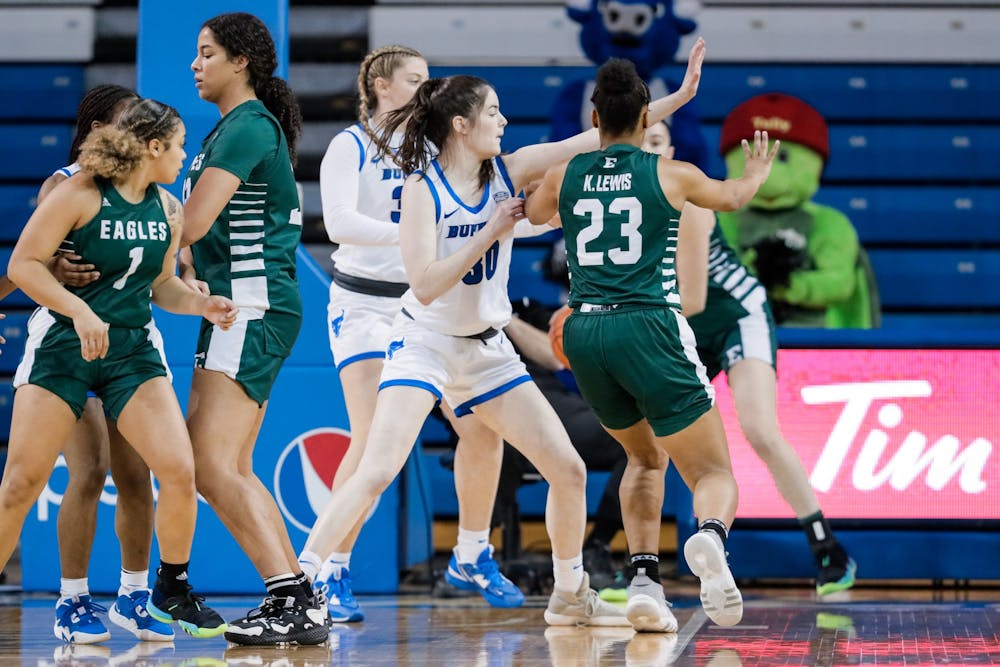 <p>Olivia DeBortoli (center) played volleyball at UB for four seasons before joining the women’s basketball team | Courtesy of UB Athletics / Paul Hokanson</p>