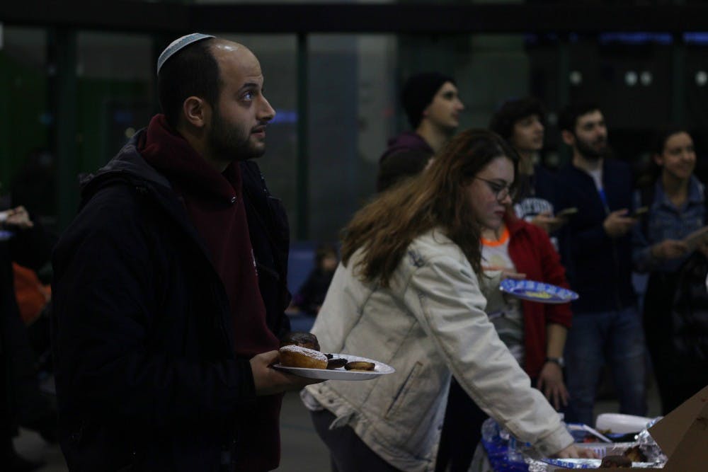 <p>Students celebrated Hanukkah in the Student Union Monday with Chabad of Buffalo. They ate traditional food, played games and collected toys and money for children with cancer in the Buffalo region.</p>