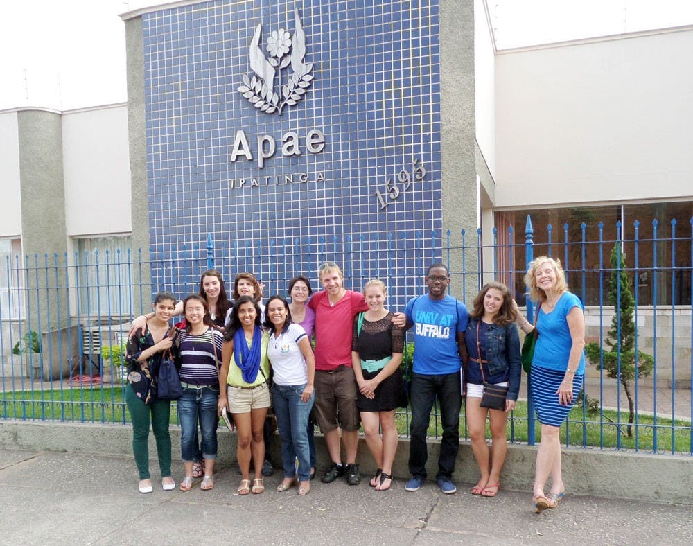 <p>Natasha Singh (bottom row, second from right) and other students involved in UB’s Health in Brazil program stand in front of APAE, one of the many medical centers they frequented during their semester abroad.</p>