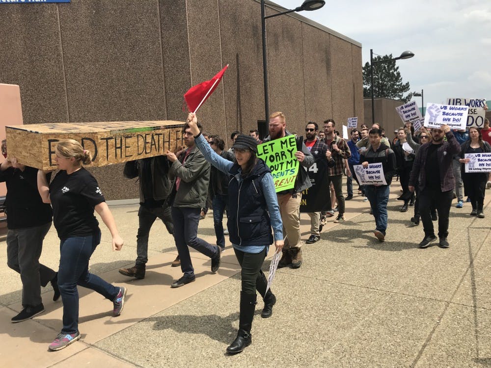 <p>&nbsp;Protesters march from Clemens Hall to Capen Hall carrying a coffin made of plywood.&nbsp;</p>