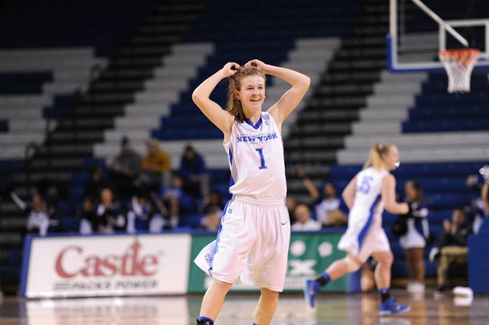 <p>Sophomore guard Stephanie Reid celebrates in a game against Akron last season in Alumni Arena. Reid and the Bulls defeated Massachusetts 56-48 on the road Saturday to start 3-0 for the first time since the 2000-01 season.&nbsp;</p>