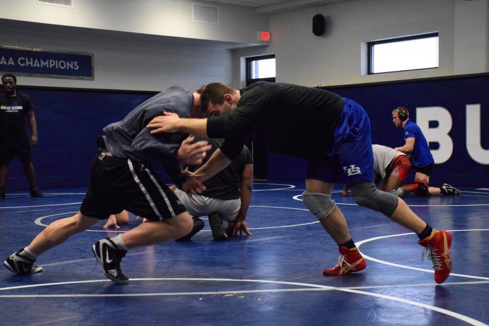 <p>Two UB wrestlers grapple at practice. The Bulls are in the midst of a resurgence.&nbsp;</p>
