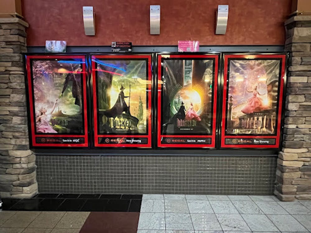 A series of promotional posters for the film, outside of the Regal Theater in Buffalo’s Walden Galleria Mall, where viewers wore pink and green, and music from the Broadway musical played in the background. 