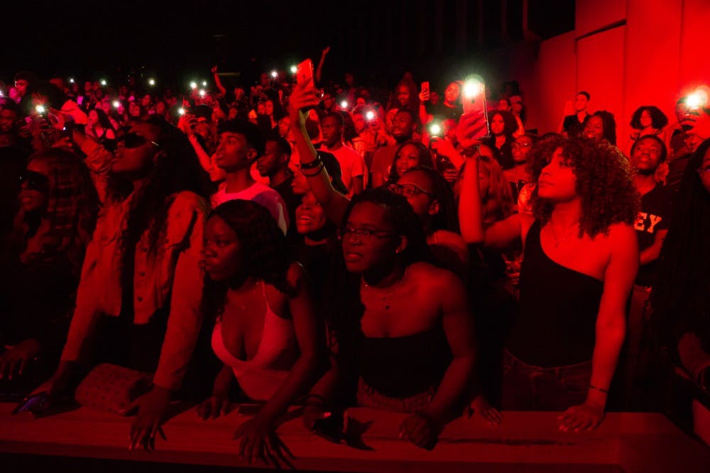 <p>Audience members light up their phones as they sing along to Kranium.</p>