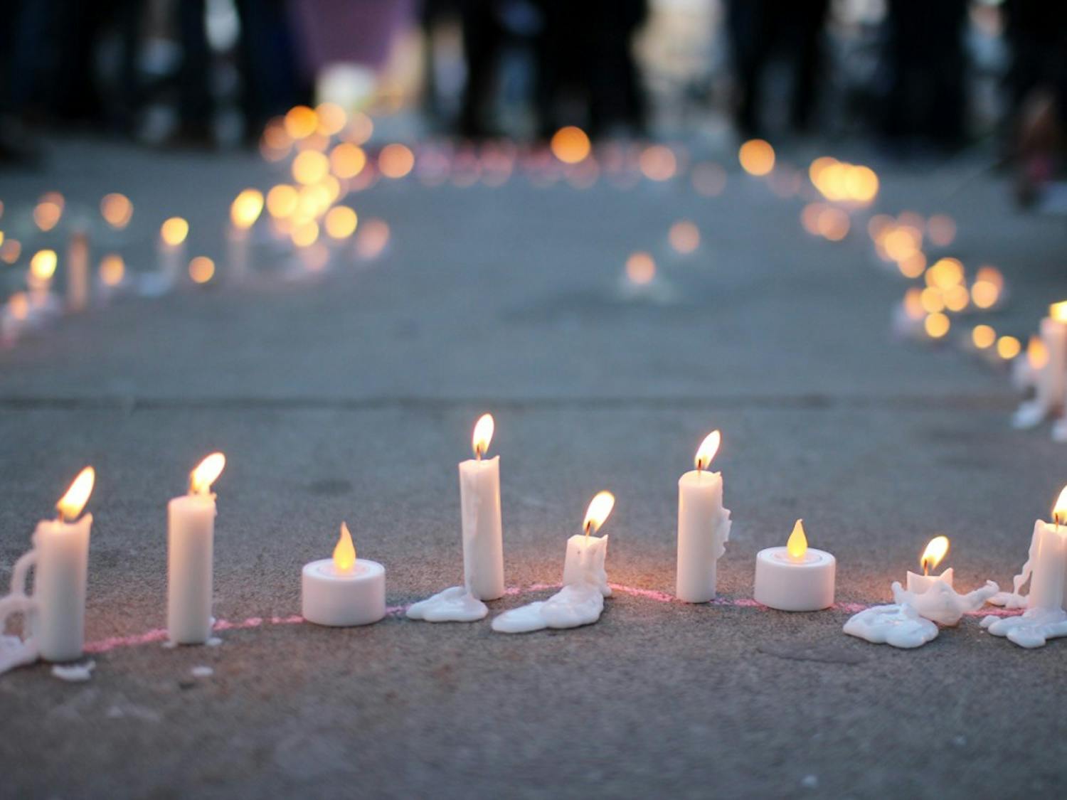 Student placed candles on the ground outside the Student Union Wednesday to honor the victims of the Nepal earthquake.