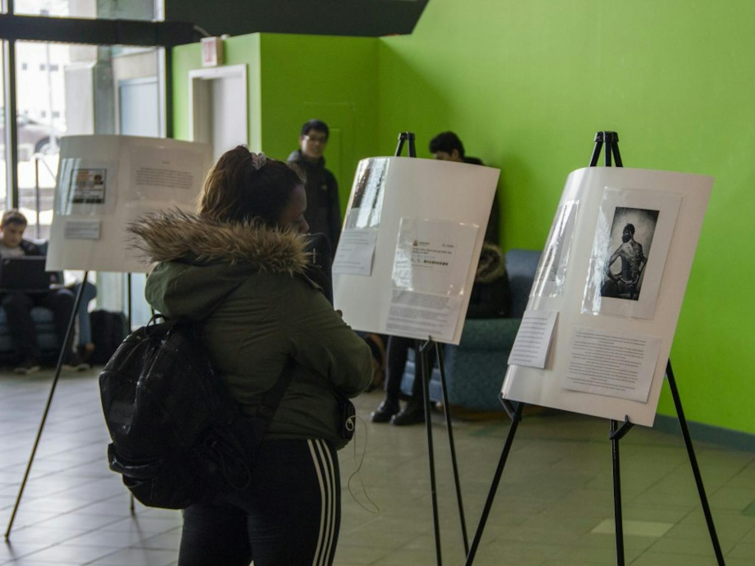 Students walk through the Student Association’s museum for Black History Month in the SU lobby. The Black Student Union, African Student Association and SA are trying to spread awareness for Black History Month.