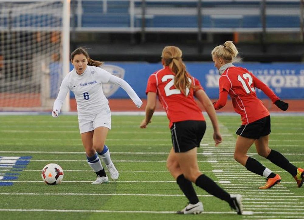 <p>Sophomore Julia Benati dribbles the ball around two defenders during a game earlier in the 2015 season. Benati was lauded by coach Shawn Burke about her ability to lead despite her underclassman status.</p>