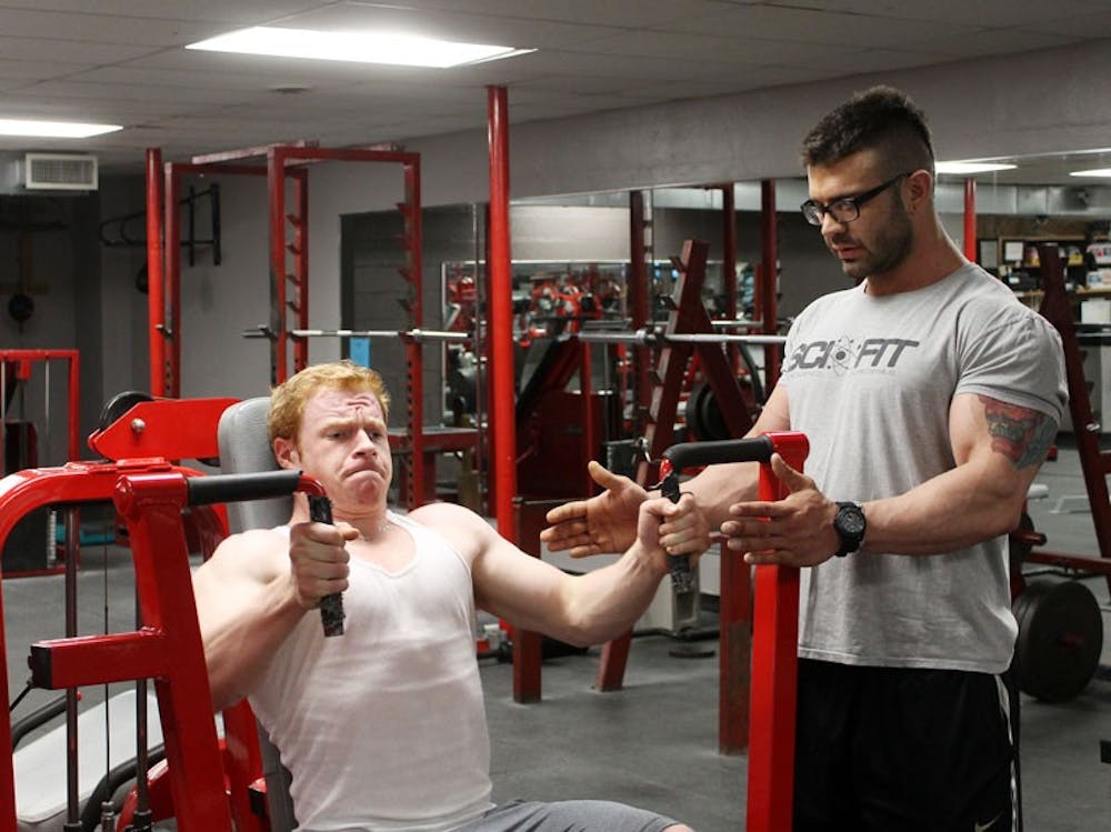 <p>UB student Jon Jeziorowski works out with fitness trainer Scott Quinn. The two are training for the Mr./Ms. Buffalo bodybuilding competition in March.</p>