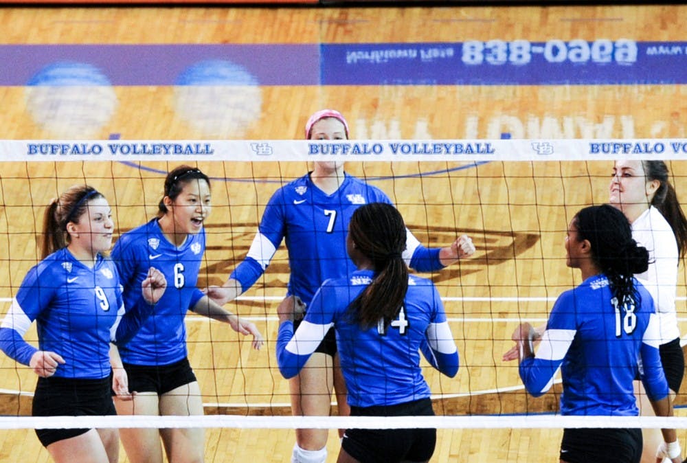 <p>Marissa Prinzbach, Megan Lin, Megan Lipski and Cassie Shado share the court during a game. The Bulls will continue its season on Saturday and will play its first home match on Sept. 24.</p>