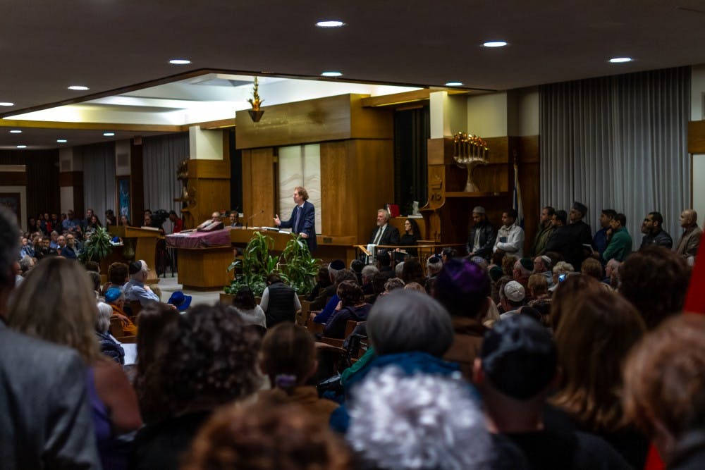 <p>Community members gather at Temple Beth Tzedek for a vigil on Sunday night.&nbsp;</p>