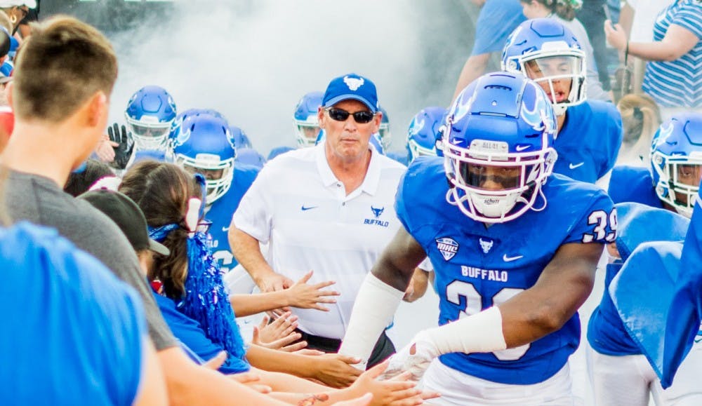 <p>Lance Leipold runs onto the field during the opening game of the 2018 season. The Bulls head coach signed a new contract worth $615,000 per year.</p>