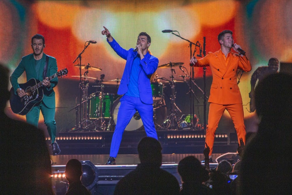 The Jonas Brother lit up the stage in vibrant colors while they entertained the crowd at the KeyBank Center Tuesday night. From left to right: Kevin Jonas, Joe Jonas and Nick Jonas. 
