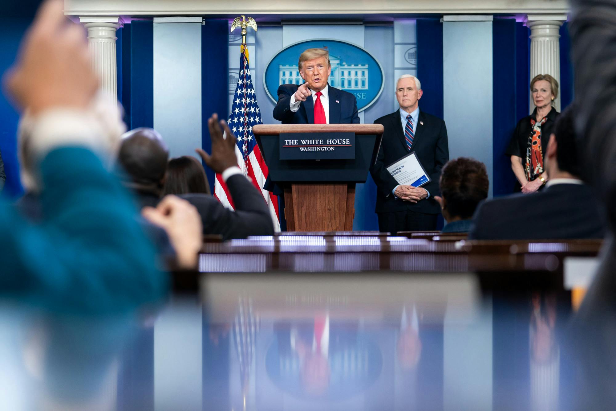 President Donald J. Trump (middle), Vice President Mike Pence (right) and members of the White House Coronavirus Task Force addresses reporters during a briefing Thursday, March 26, 2020, in the James S. Brady Press Briefing Room of the White House. 