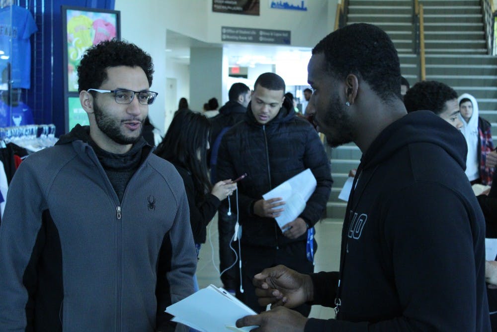 <p>Members of the UB football team talk to students about registering to the Be The Match national bone marrow donation program. Linebacker Matt Otwinowski will be donating next week.</p>