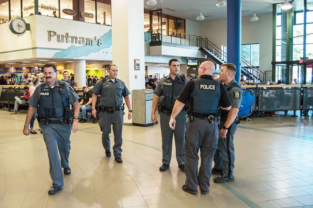 <p>UPD officers stand in the Student Union.&nbsp;UPD sent out a campus-wide alert for only one of the four sexual assault&nbsp;incidents reported last month.</p>