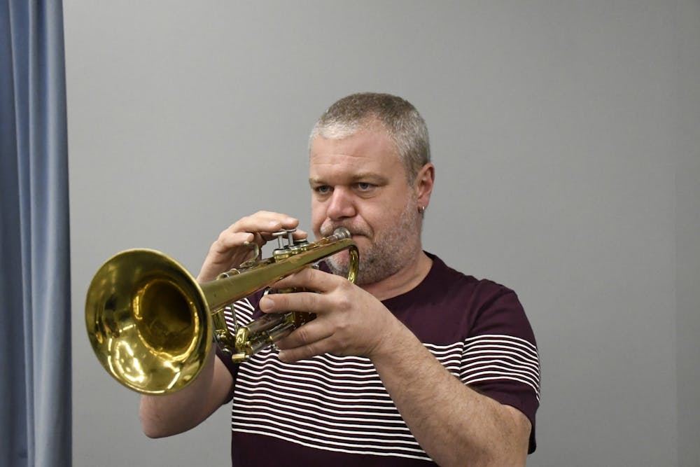 Jon Nelson plays a trumpet.