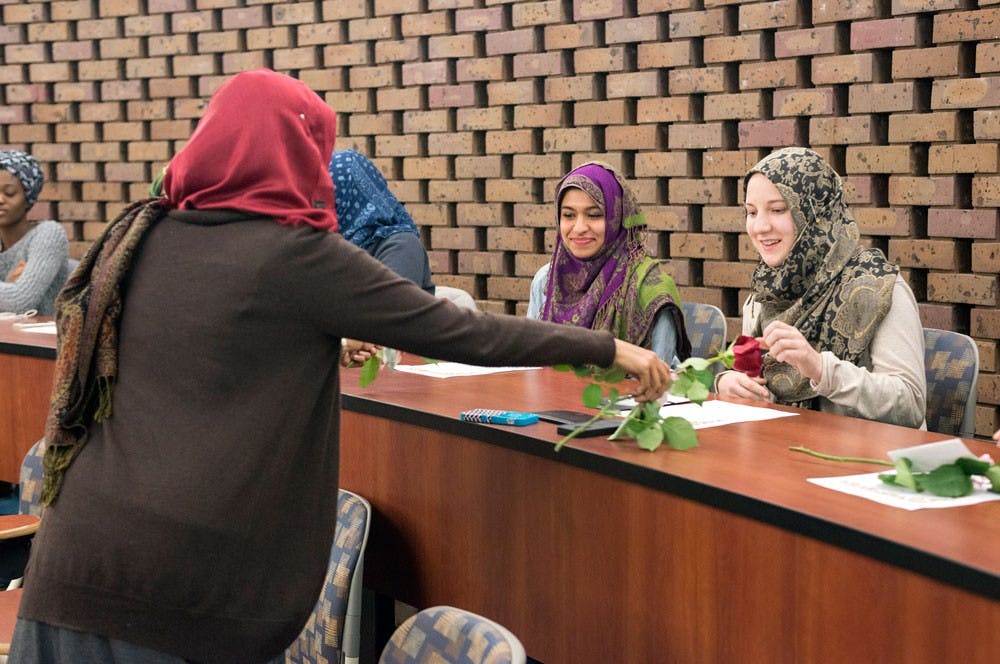 The Muslim Women's Council distributed roses to the participants in their "Cover a Mile in Her Scarf" event at the discussion panel Friday evening.