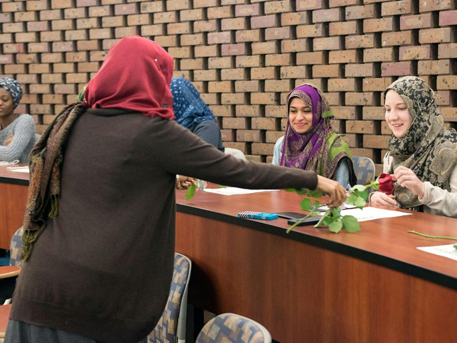 The Muslim Women's Council distributed roses to the participants in their "Cover a Mile in Her Scarf" event at the discussion panel Friday evening.