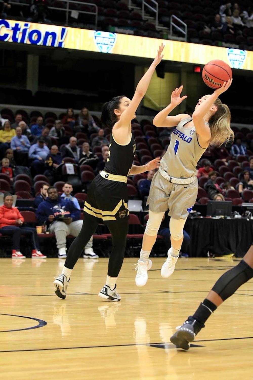 <p>Senior guard Stephanie Reid looks for the layup in the crowded paint. The Bulls made program history Monday securing the team's first appearance in the Sweet Sixteen of the NCAA Tournament.&nbsp;</p>