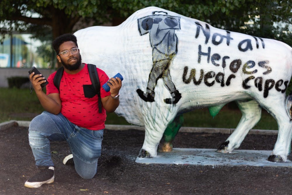 <p>‘Boombox Guy’ in front of the SU Bull.</p>