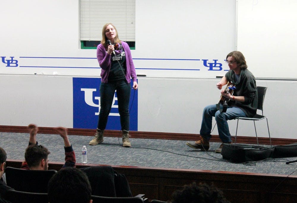 <p>Rachel Sawyer, a senior English major, (left) performed a rendition of Amy Winehouse’s “Valerie” on stage at the UB Improv’s Open Mic Night Wednesday night.</p>