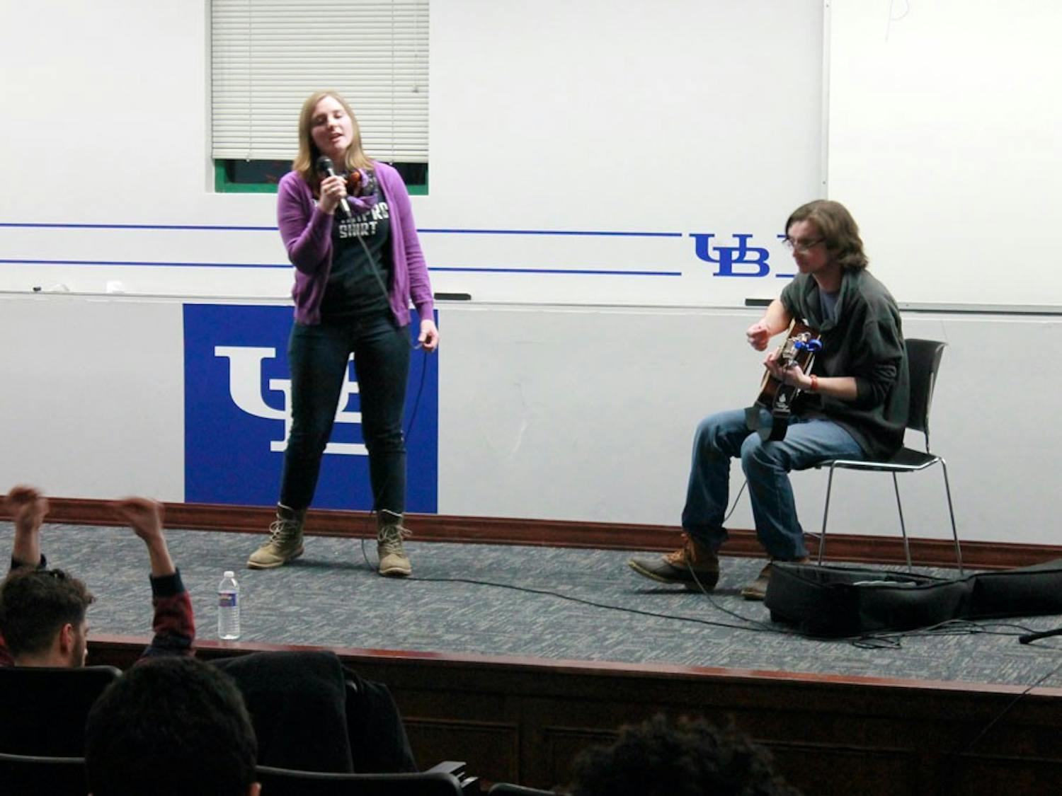 Rachel Sawyer, a senior English major, (left) performed a rendition of Amy Winehouse’s “Valerie” on stage at the UB Improv’s Open Mic Night Wednesday night.