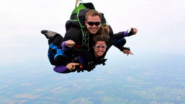 Jason Berger, founder of UB Skydiving, jumps with former student Jillian Schuppenhauer. On Saturday, Berger will dive into UB Stadium to deliver the football team&#39;s game ball.
Courtesy of Jason Berger