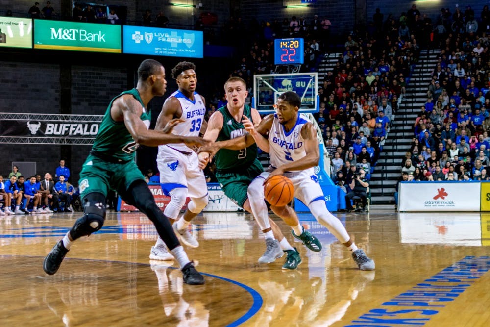 Senior guard CJ Massinburg looks to break through the defense with help from senior forward Nick Perkins. Massinburg tied the school record for points in a season last year and looks to beat it this year.