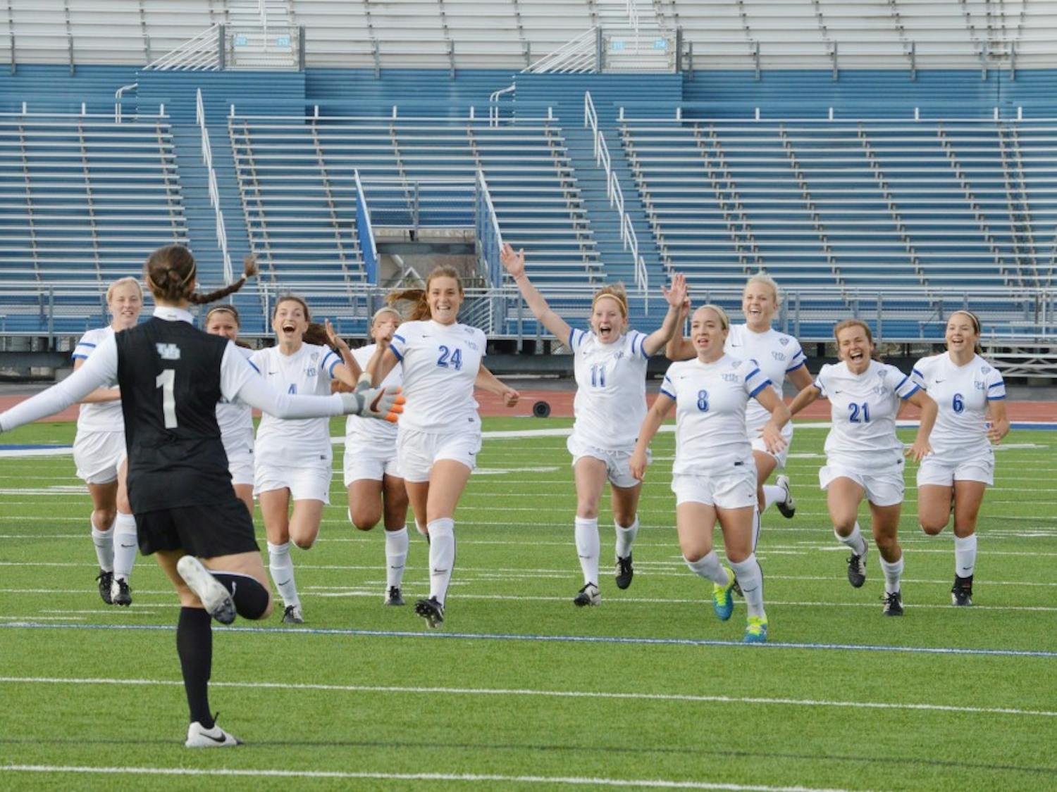 The women’s soccer team rushes to celebrate with sophomore goalkeeper Laura Dougall (1) after a win over Central Michigan in the MAC Quarterfinals at UB Stadium Sunday. Buffalo will advance to the MAC Semifinals against Western Michigan next weekend.